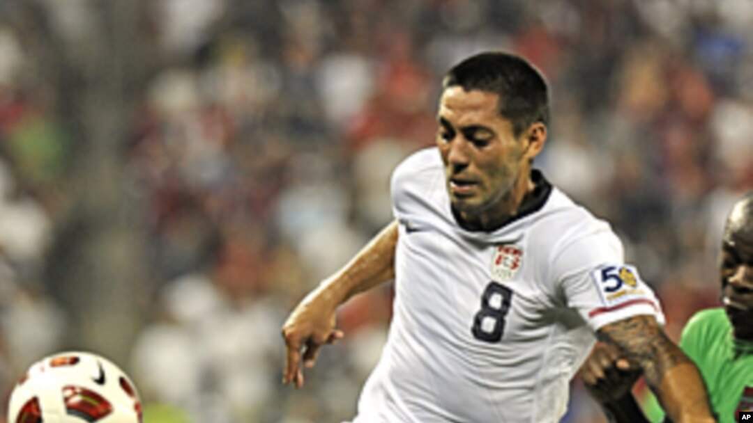 United States' Clint Dempsey (8) holds off a challenge by a Guadeloupe player during their CONCACAF Gold Cup match at Livestrong Stadium in Kansas City, Kansas June 14, 2011