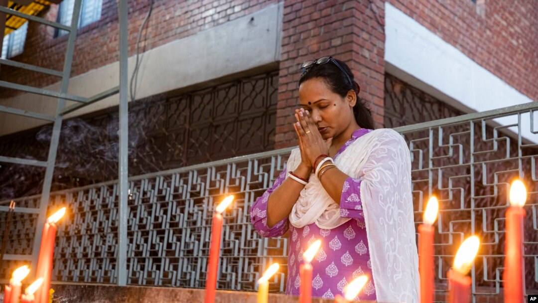 A Hindu woman prays at the Dhakeshwari National Temple in Dhaka, Bangladesh, Aug.11, 2024.