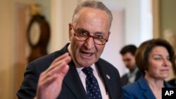 Senate Minority Leader Chuck Schumer, D-N.Y., joined at right by Sen. Amy Klobuchar, D-Minn., speaks to reporters at the Capitol in Washington, April 9, 2019.