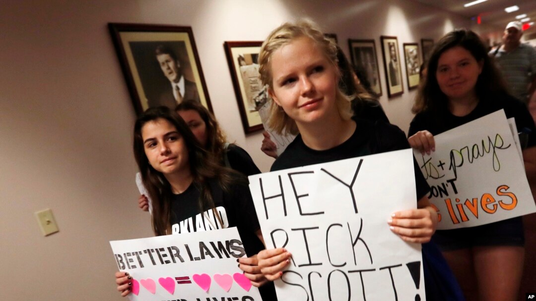 FILE - Student survivors from Marjory Stoneman Douglas High School walk through the halls of the state capitol to challenge lawmakers on gun control reform, in Tallahassee, Florida, Feb. 21, 2018.