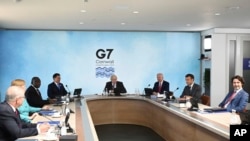 G-7 summit participants are seen during a session in Cornwall, England, June 12, 2021, with summit host, Britain's Prime Minister Boris Johnson, presiding. 