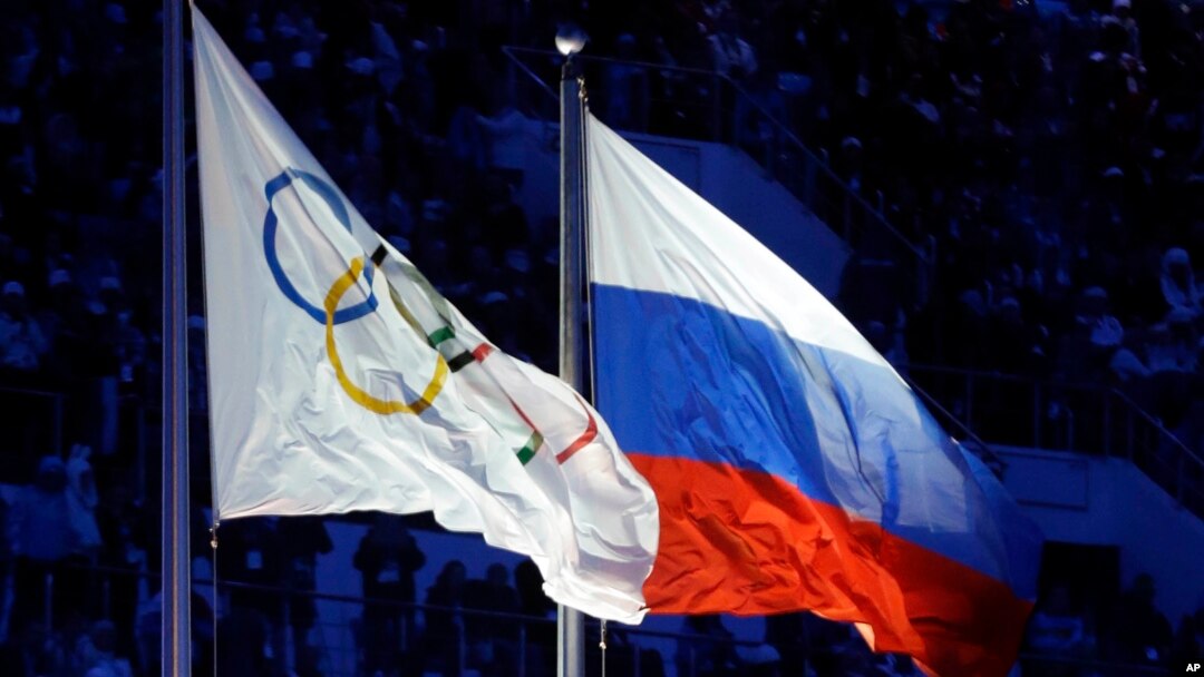 FILE - The Russian and the Olympic flags wave during the opening ceremony of the 2014 Winter Olympics in Sochi, Russia, 7, 2014. 