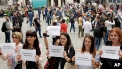 Bosnian journalists hold up banners reading "Journalism is no crime" and "Stop violence against journalists," in downtown Sarajevo to protest the beating of a journalist in Banja Luka, the main city in the Serb-run part of Bosnia, Aug. 28, 2018.