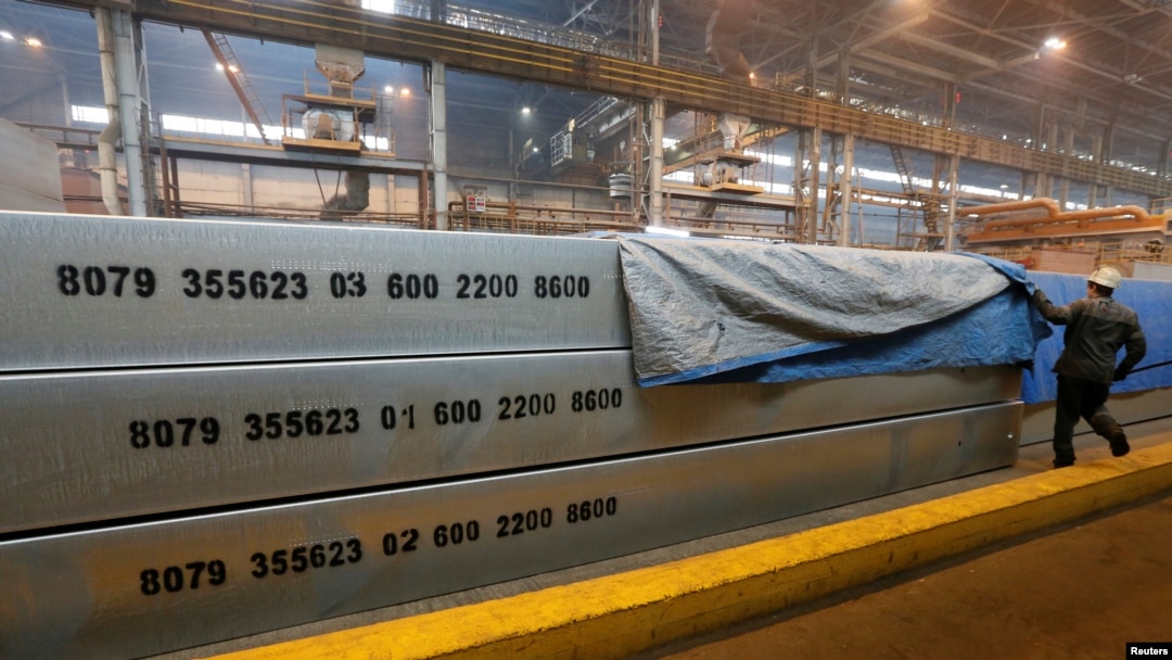 FILE - An employee removes a covering of aluminium ingots at the foundry shop of the Rusal Krasnoyarsk aluminium smelter in Krasnoyarsk, Russia, July 27, 2016. Russia is demanding compensation from the U.S. for its worldwide tariffs on foreign aluminum and steel Thursday, becoming the third influential member of the World Trade Organization to do so.