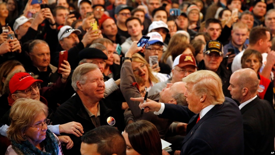 People greet Republican presidential candidate Donald Trump, bottom right, after he spoke at a rally at the Surf Ballroom in Clear Lake, Iowa, Jan. 9, 2016.
