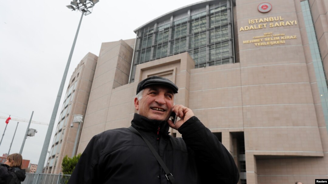 Ali Riza Tolu, father of imprisoned German journalist Mesale Tolu, talks with his mobile phone in front of the Justice Palace, the Caglayan courthouse, in Istanbul, Turkey, Dec. 18, 2017. 