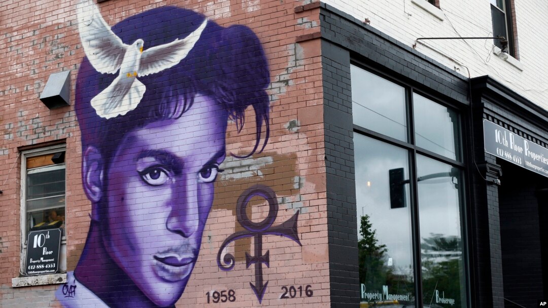 FILE - A mural honoring the late Prince adorns a building in the Uptown area of Minneapolis, Aug 28, 2016.