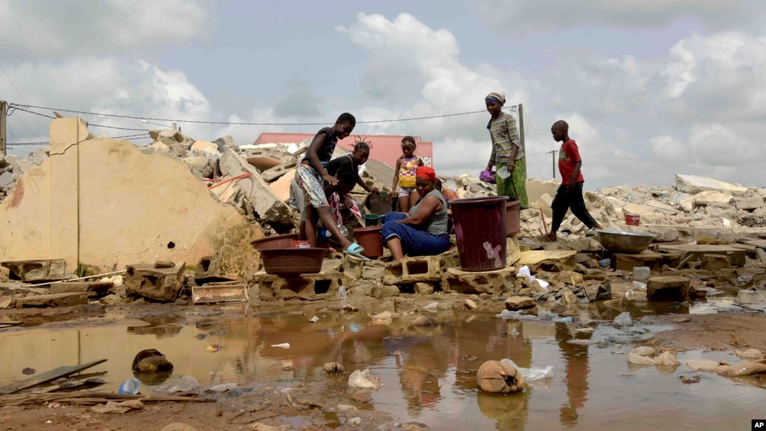 People whose houses were demolished on public health grounds collect water in the Gesco neighborhood of Abidjan, Ivory Coast, Feb. 28, 2024. Rapid urbanization has led to a population boom and housing shortages in Abidjan, where nearly one in five Ivorians reside.