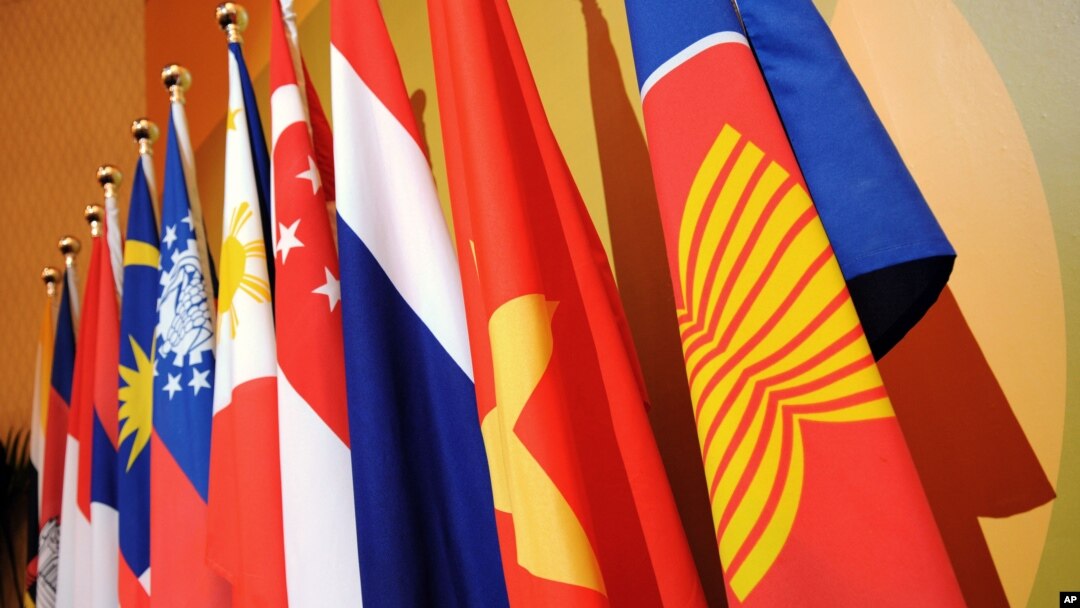 FILE - The Association of the Southeast Asian Nations (ASEAN) flag, right, leads the flags of the 10 member countries during the ASEAN Regional Forum meeting in Singapore.