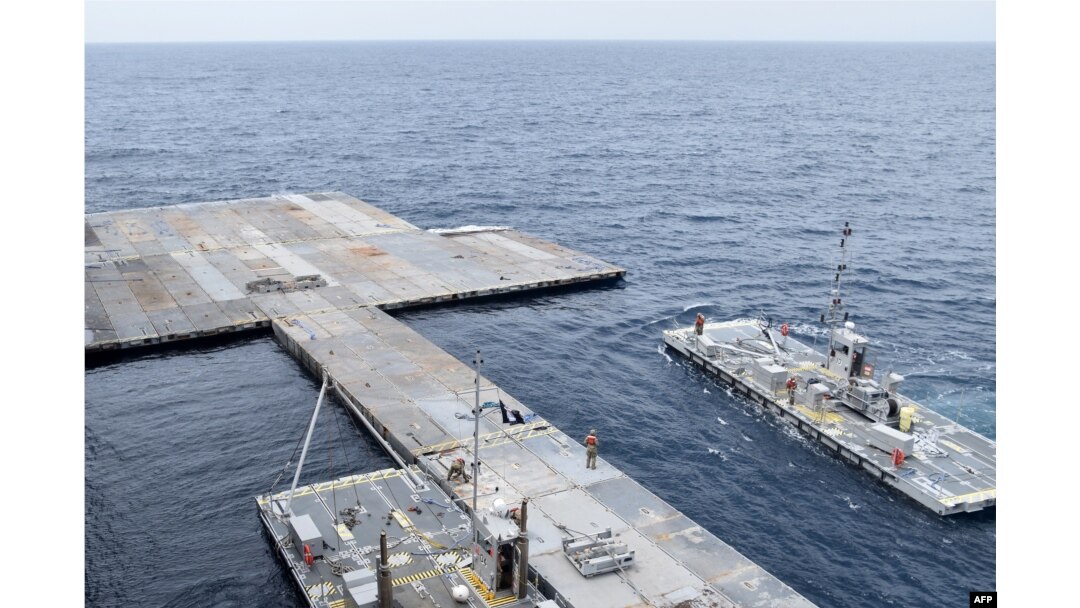 FILE - In this photo provided by the U.S. Central Command and taken on April 26, 2024, construction work continues on the floating pier in the Mediterranean Sea.