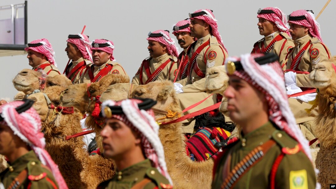 An honor guard on camelback greets Saudi Arabia's King Salman, not seen, in a lavish welcome ceremony complete with cannon salutes, in Amman, Jordan, March 27, 2017. Salman is in Jordan to attend the annual Arab Summit, to be held March 29.