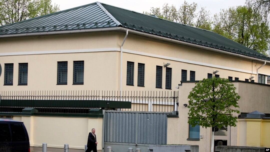 FILE - A man walks past the U.S. Embassy in Minsk, Belarus, May 1, 2008.