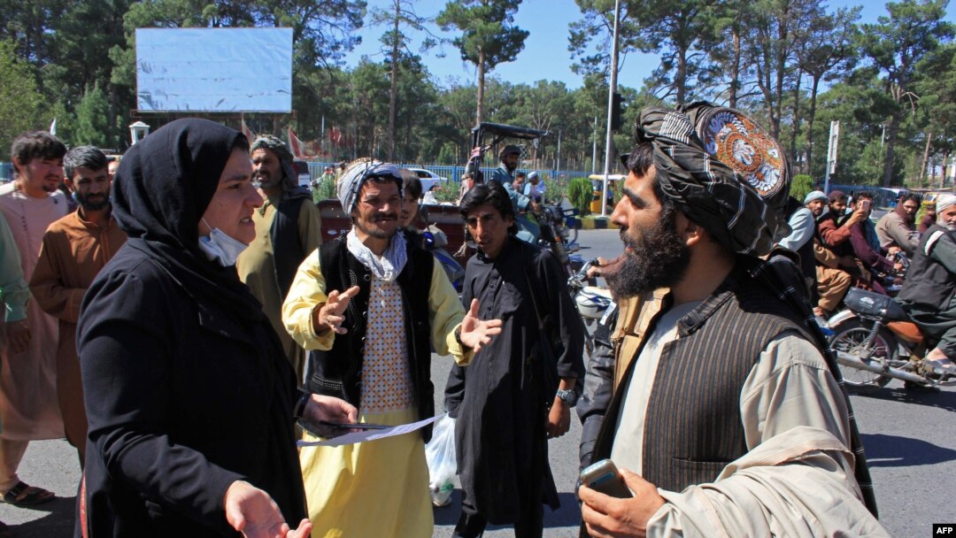An Afghan woman protester speaks with a member of the Taliban during a protest in Herat on Sept. 2, 2021.