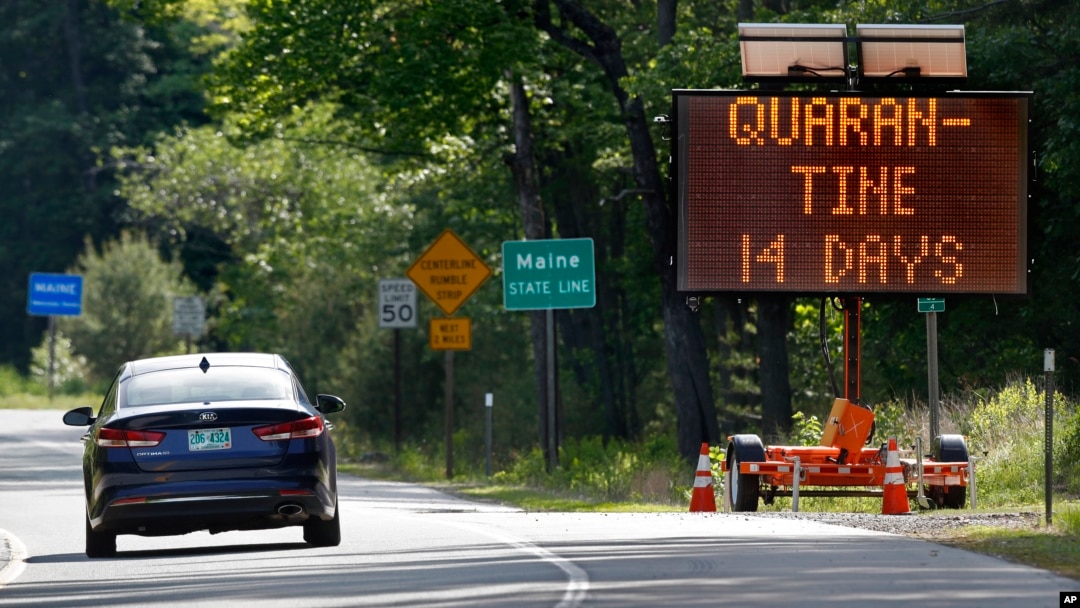 In this Wednesday, June 10, 2020, photo, a sign in Gilead, Maine, near the border with New Hampshire, warns visitors entering Maine that they are required to quarantine for 14 days. Residents of New Hampshire and Vermont are exempt. (AP Photo/Robert F. Bu