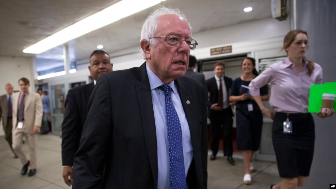 FILE - Democratic presidential candidate Sen. Bernie Sanders, I-Vt. heads to the Senate chamber on Capitol Hill in Washington, June 26, 2016. Sanders supporters failed to include language opposing the Trans-Pacific Partnership trade deal in a draft of the