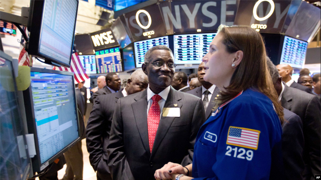 John Evans Atta Mills, the President of Ghana, visits the floor of the New York Stock Exchange, Dec. 15, 2011, and talks with specialist Jennifer Klesaris. 