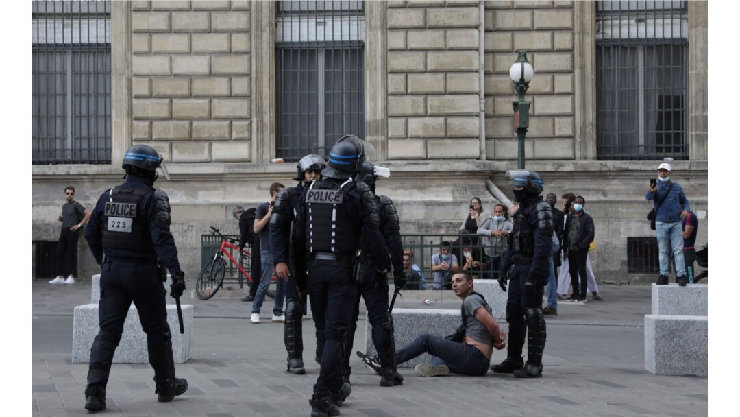 Police detain a protester during a demonstration in Paris, France, July 31, 2021. Demonstrators gathered in several cities to protest against the COVID-19 pass, which grants vaccinated individuals greater ease of access to venues.