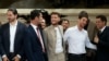 French newly elected member of parliament for La France Insoumise (LFI) from the leftist coalition New Popular Front Raphael Arnault, center, and colleagues arrive to France's National Assembly in Paris on July 9, 202
