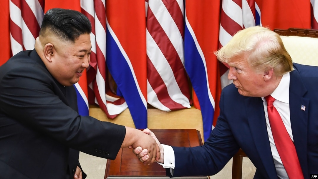 FILE - In this photo taken on June 30, 2019, North Korea's leader Kim Jong Un and US President Donald Trump shake hands during a meeting on the south side of the Military Demarcation Line that divides North and South Korea.