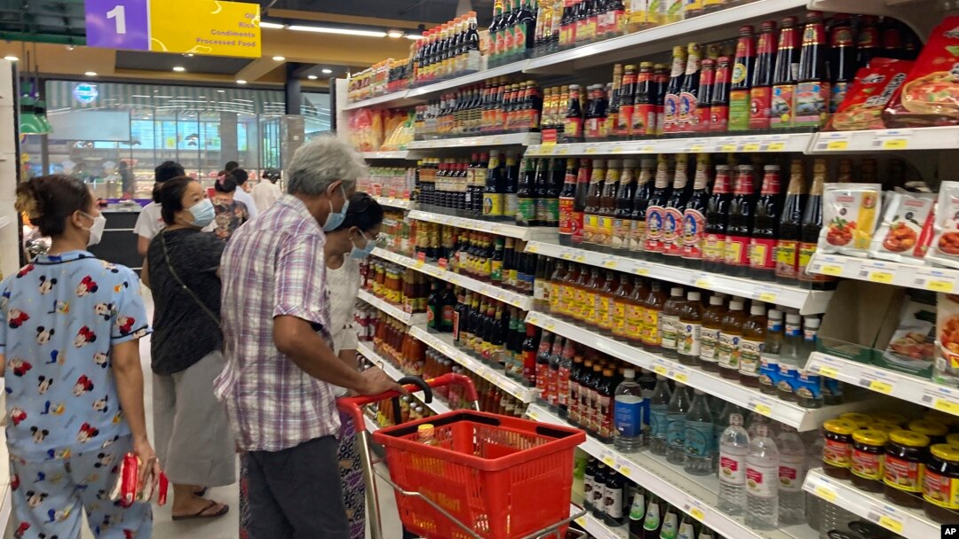 FILE - People buy food and other grocery items at a supermarket in Yangon, Myanmar, Sept. 7, 2021.