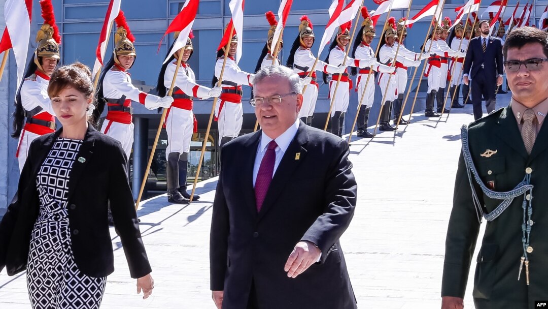 FILE - The handout photo released by the Brazilian presidency shows Greece's ambassador to Brazil, Kyriakos Amiridis, center, in Brasilia, May 25, 2016.