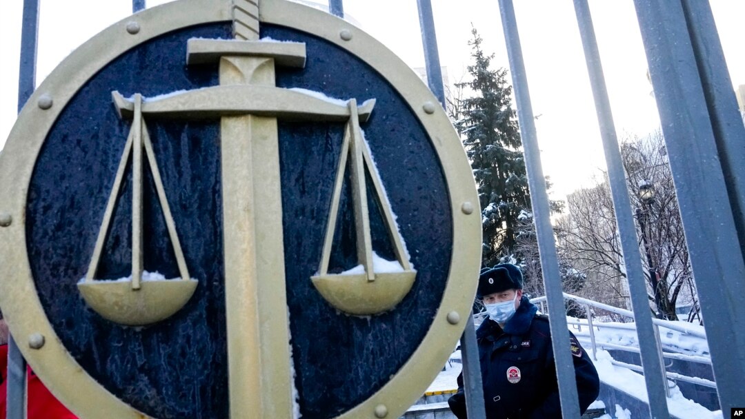 FILE - A police officer guards an entrance of a court, in Moscow, Russia, Dec. 29, 2021. Sergei Mingazov, a Forbes Russia journalist, has been detained in Russia over social media posts he made about Ukraine.