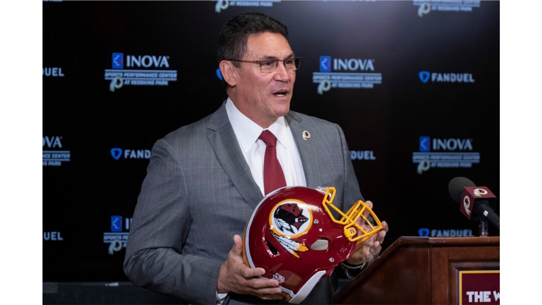 Washington Redskins head coach Ron Rivera holds up a helmet during a news conference at the team's NFL football training facility in Ashburn, Virginia, Jan. 2, 2020.