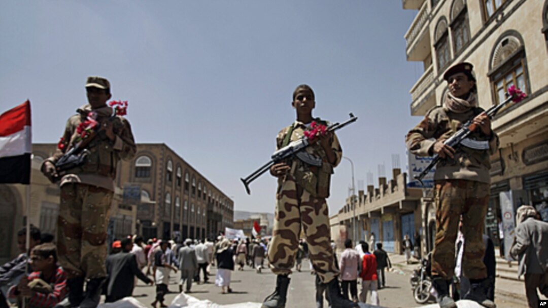 Former government soldiers stand guard as protesters demand President Saleh's resignation, Sana'a, Oct. 6, 2011.