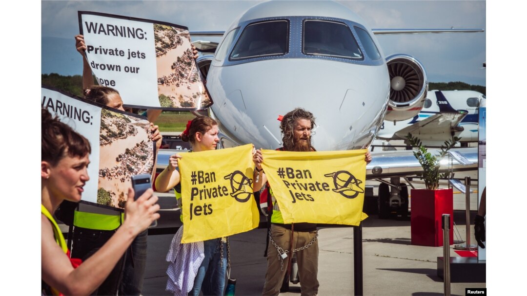 Activists hold banners during a demonstration against Private jets at the European Business Aviation Convention & Exhibition (EBACE) in Geneva, Switzerland, May 23, 2023. Thomas Wolf/Stay Grounded/Handout via REUTERS