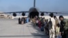 Passengers board a US Air Force C-17 Globemaster III at Hamid Karzai International Airport, Afghanistan, August 24, 2021. (US Air Force Photo)