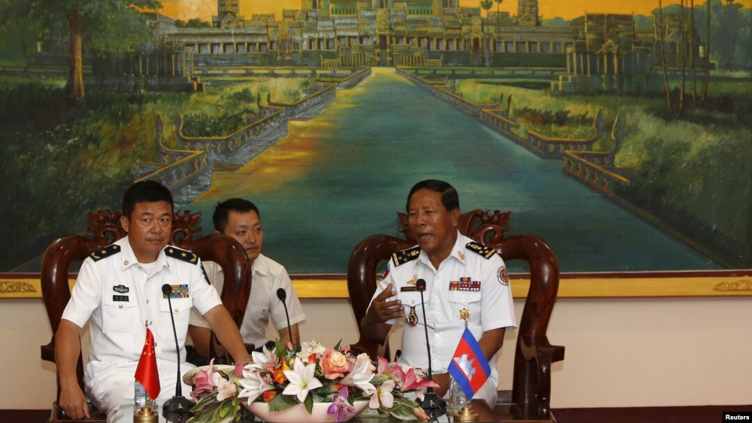 Tea Vinh, commander of the Royal Cambodian Navy (R), welcomes Yu Manjiang, commanding officer of the Chinese fleet visiting Cambodia, in Phnom Penh, Feb. 24, 2016.