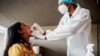 A nurse from Lancet Nectare hospital (R) performs a COVID-19 coronavirus test in Richmond, South Africa, Dec. 18, 2020. (Photo by LUCA SOLA / AFP)