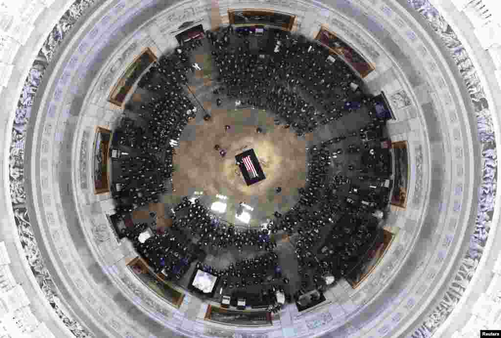 Cindy McCain, wife of the late U.S. Sen. John McCain, R-Ariz., stands over his casket as he lies in state in the U.S. Capitol Rotunda in Washington, D.C.