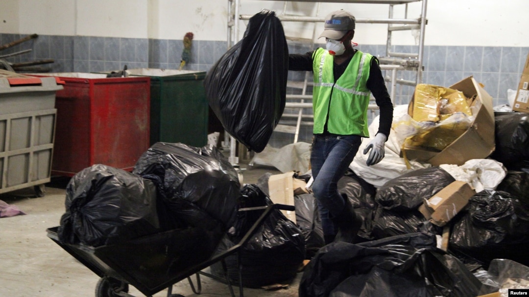 Workers from an environmentally-friendly rubbish disposal business called ScrapApp sort through garbage in a shopping mall in Noida, India, Aug. 11, 2016.