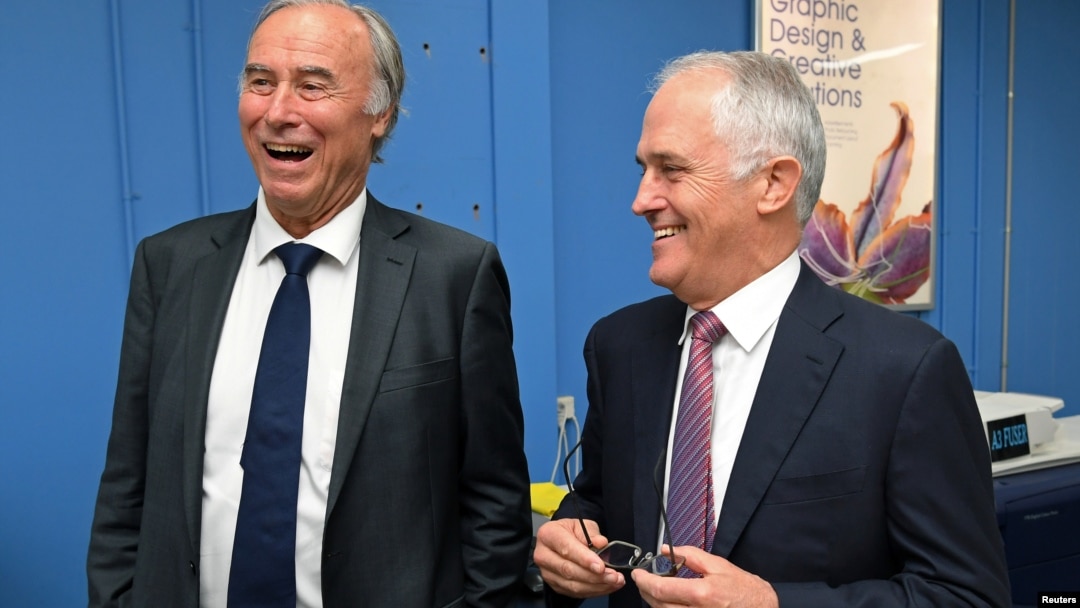 Conservative Liberal party MP John Alexander laughs as he stands with Australian Prime Minister Malcolm Turnbull during a visit to a printing company in Sydney, Australia, April 4, 2017.