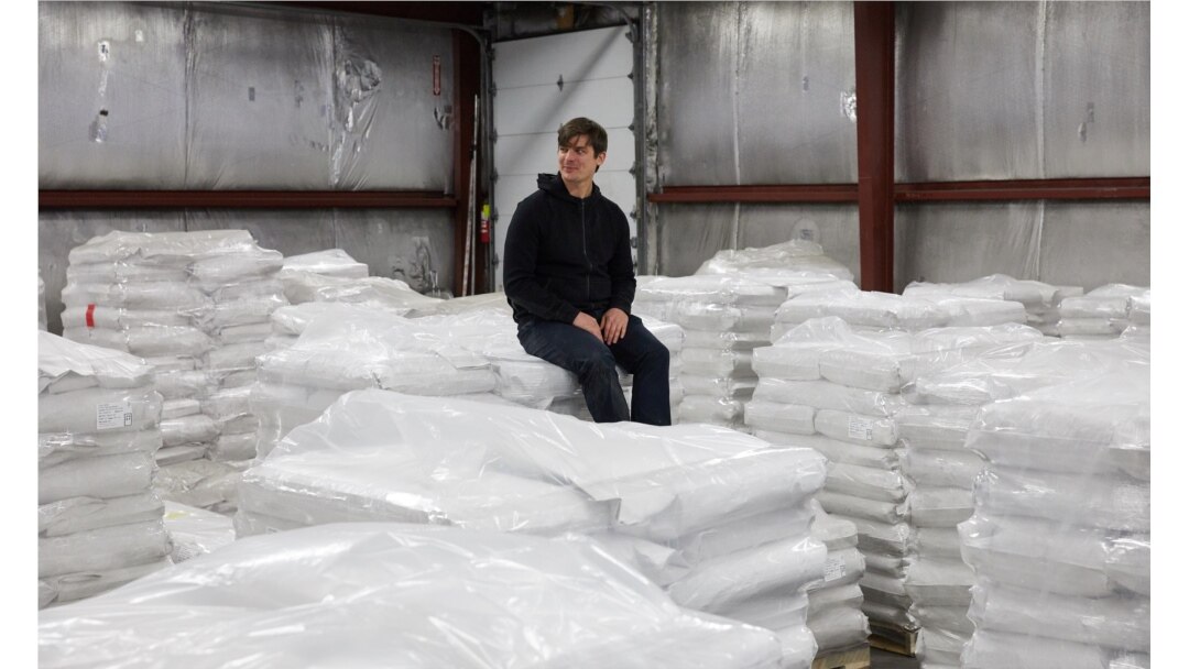 FILE - CEO and founder of Eat Just Josh Tetrick sits on bags of plant protein at the Eat Just facility in Appleton, Minnesota, December 2019. (Eat Just, Inc./Handout via REUTERS)