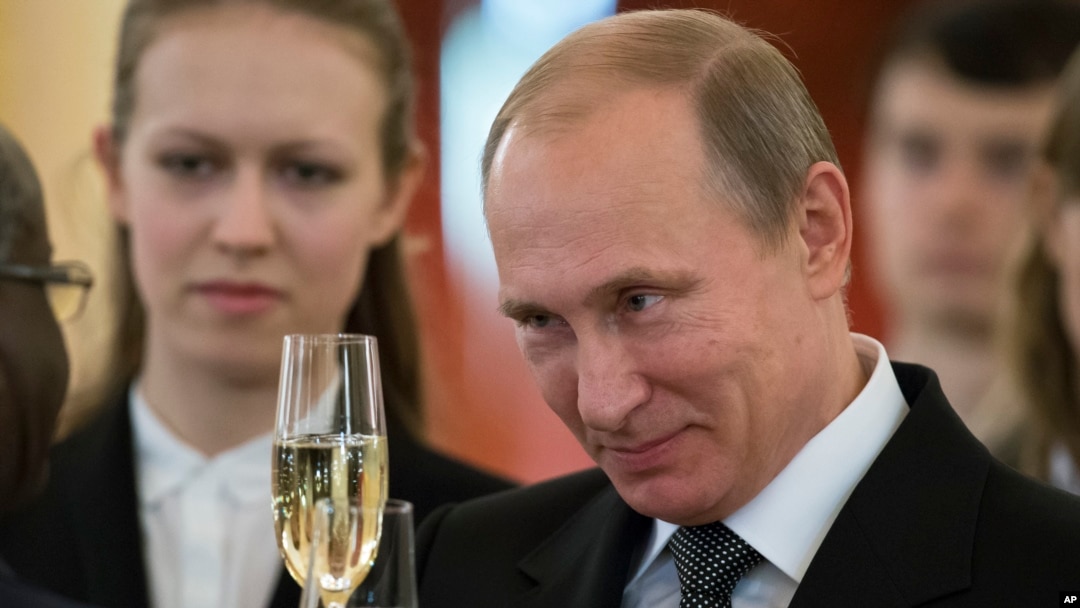 FILE - Russian President Vladimir Putin toasts with ambassadors after a ceremony of presentation of credentials by foreign ambassadors in the Grand Kremlin Palace in Moscow.