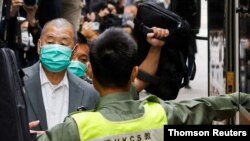 FILE - Media mogul Jimmy Lai leaves the Court of Final Appeal by prison van in Hong Kong, Feb. 9, 2021.