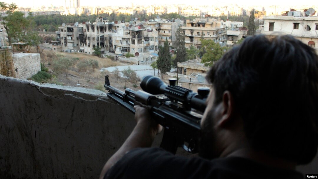 A Free Syrian Army sniper looks through the scope of his rifle at an area controlled by forces loyal to Syria's President Bashar al-Assad in Aleppo' September 11, 2013.Analysts say the FSA lacks effective leadership.