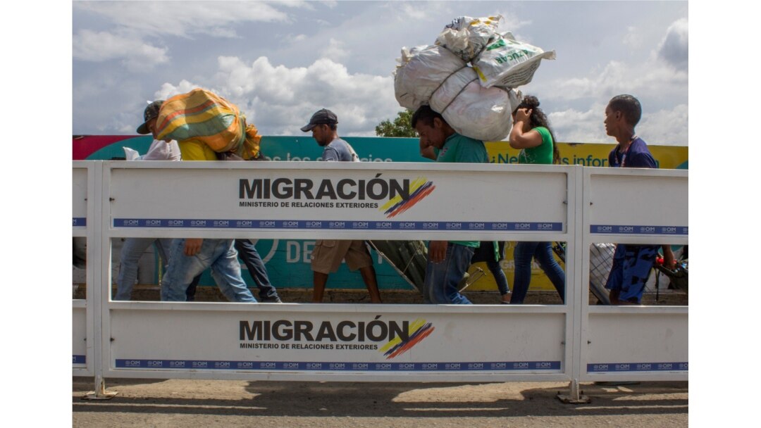 Men carry large loads on their backs as they work as “lomo taxistas,” or taxis of the lower back, across the border from Cucuta, Colombia, to Venezuela, Sept. 20, 2019.