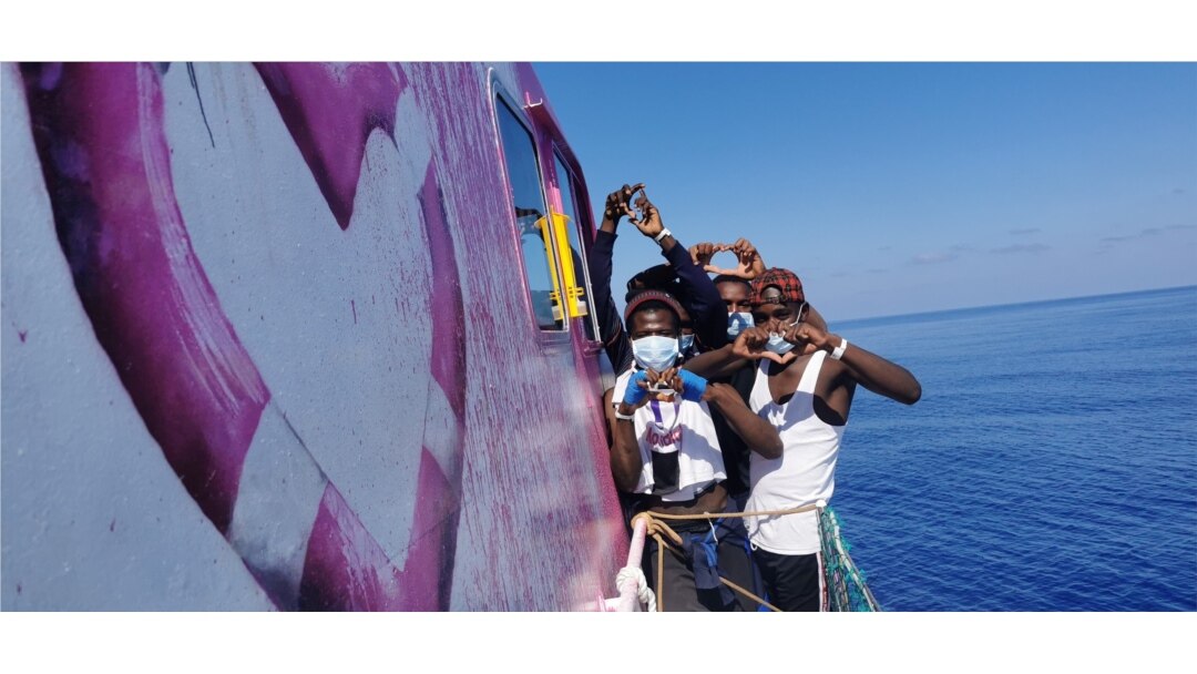 In this undated handout photo, people pose after being rescued by the Louise Michel, a migrant search-and-rescue ship operating in the Mediterranean and financed by British street artist Banksy, at sea. (MV Louise Michel/Handout via Reuters)