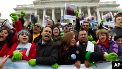 FILE - Rep. Luis Gutierrez (D-Illinois), third from left, along with other demonstrators protest outside of the U.S. Capitol in support of the Deferred Action for Childhood Arrivals (DACA) during a rally on Capitol Hill in Washington, Dec. 6, 2017.