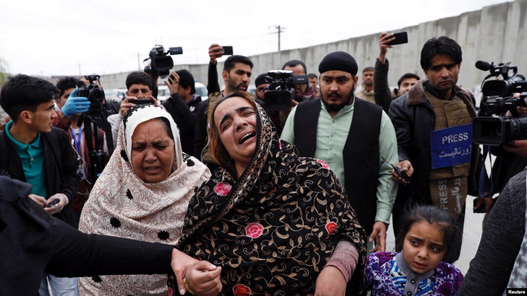 An Afghan Sikh woman mourns for her relatives near the site of an attack in Kabul, Afghanistan March 25, 2020.