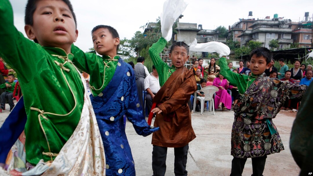 Tibetan boys dance during celebrations to mark the 82nd birthday of their spiritual leader the Dalai Lama at a Tibetan camp in Lalitpur, Nepal, July 6, 2017.
