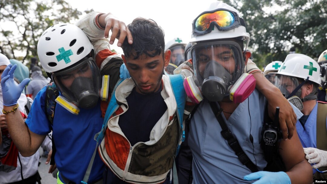 Volunteers help an injured demonstrator (center) during a rally against Venezuela's President Nicolas Maduro in Caracas, Venezuela, April 24, 2017. 