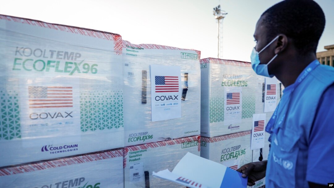 FILE - A worker checks boxes of a coronavirus vaccine following their delivery at the airport in Nairobi, Kenya, Aug. 23, 2021. 