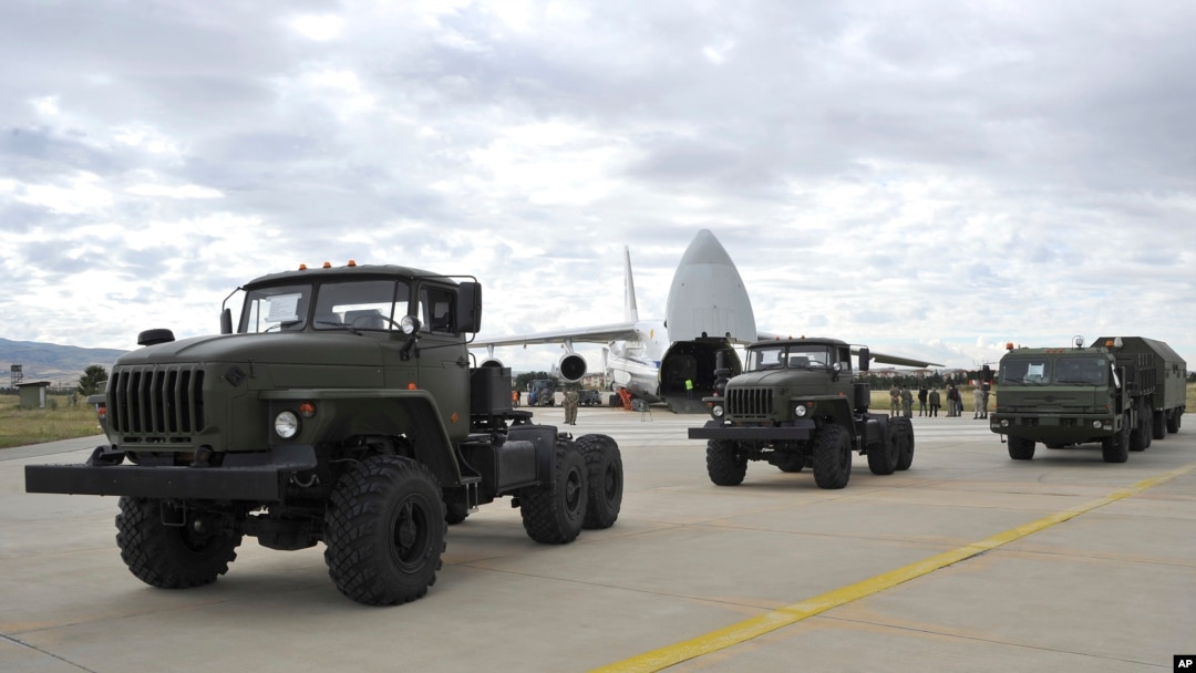 FILE - Military vehicles and equipment, parts of the S-400 air defense systems, are seen on the tarmac, after they were unloaded from a Russian transport aircraft, at Murted military airport in Ankara, July 12, 2019.