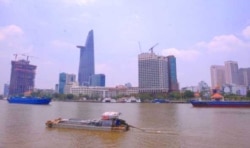A view over the Saigon river next to Ho Chi Minh city's financial district. An expert in illegal wildlife trafficking says many of the people involved in the illicit trade in rhino horn are from this and other Vietnamese cities.