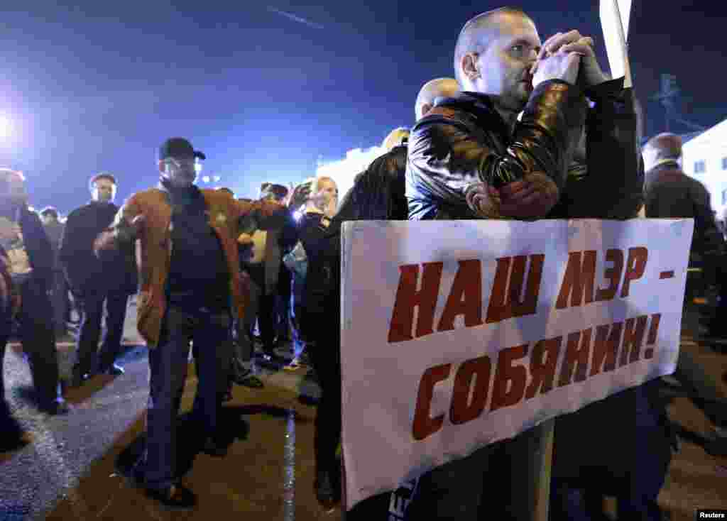 Participants celebrate during a rally for supporters of current Moscow mayor Sergei Sobyanin after voting in the mayoral election in Moscow, Sept. 8, 2013.