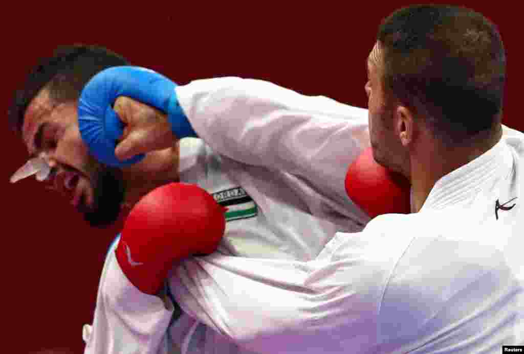 Mahmoud Sajan of Jordan competes against Zniollah Poorshab of Iran during the men's-84kg karate match at the 2018 Asian Games in Jakarta, Indonesia.